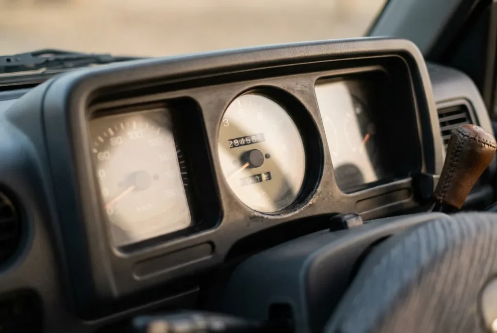 Suzuki Jimny odometer showing high mileage in a clean cabin